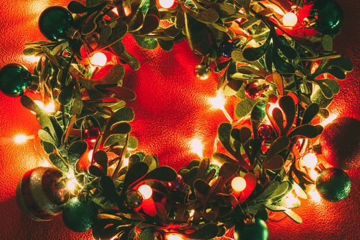 Greeting Season concept.Christmas wreath with decorative light on red background