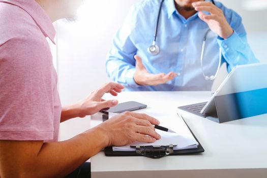 Medical doctor using mobile phone and consulting businessman patient having exam as Hospital professionalism concept 