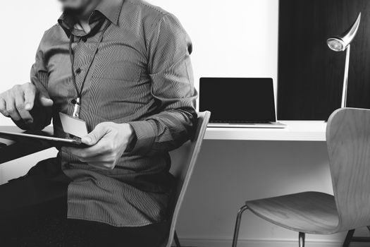 businessman working with digital tablet and laptop computer and card tag in modern office,black and white