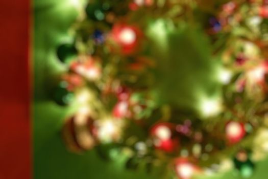 Greeting Season concept.Blur Christmas wreath with decorative light on dark wood background