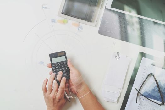 top view of businessman hand working with finances about cost and calculator and latop with mobile phone on withe desk in modern office with VR icon diagram