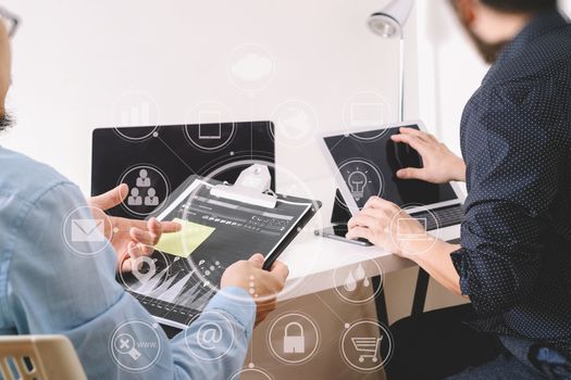 co working team meeting concept,businessman using smart phone and digital tablet and laptop computer in modern office with virtual icon graph and chart