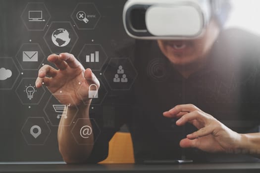 businessman wearing virtual reality goggles in modern office with Smartphone using with VR headset with screen icon diagram