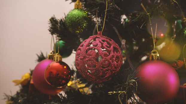 Greeting Season concept.close up of ornaments on a Christmas tree with decorative light