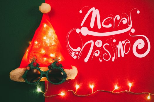 Greeting Season concept.Santa Claus hat with star light and glasses that decoration with Christmas tree on red and green background