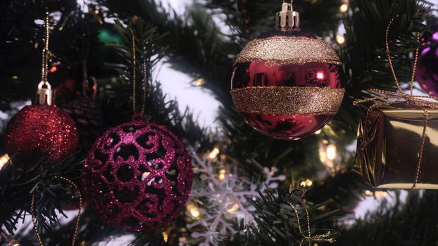 Greeting Season concept.close up of ornaments on a Christmas tree with decorative light