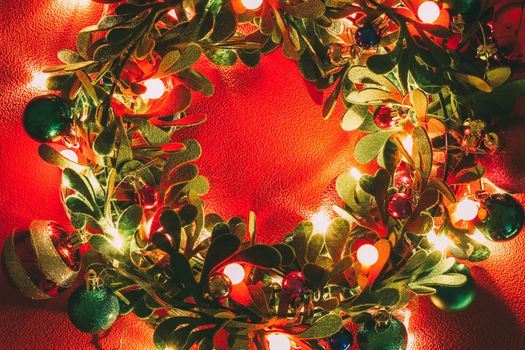 Greeting Season concept.Christmas wreath with decorative light on red background