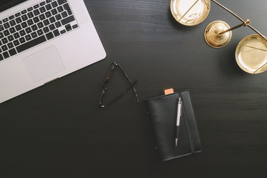 justice and law concept.Lawyer workplace with laptop and documents with dark wooden