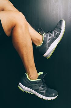 Runner sportsman holding ankle in pain with Broken twisted joint running sport injury and Athletic man touching foot due to sprain on dark background