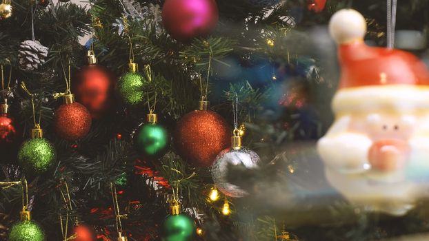 Greeting Season concept.close up of ornaments on a Christmas tree with decorative light