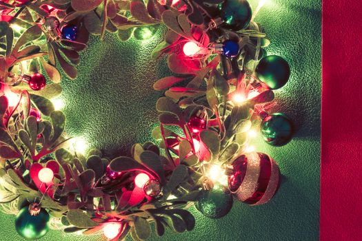 Greeting Season concept.Christmas wreath with decorative light on green background