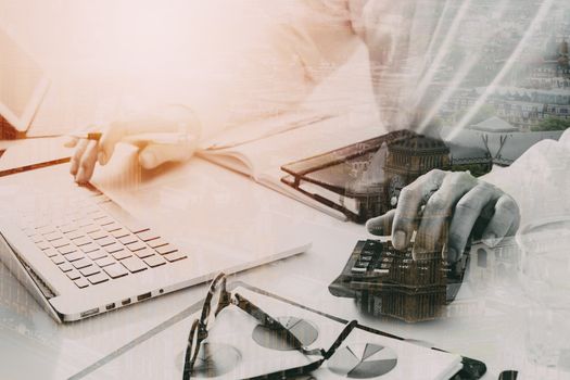 businessman hand working with finances about cost and calculator  and latop with mobile phone on withe desk in modern office with city exposure