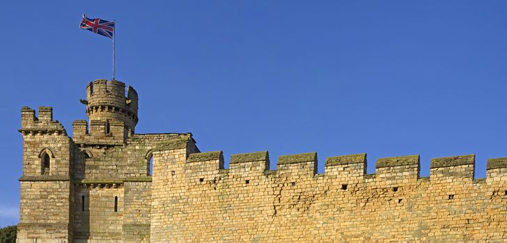 Panoramic view of an old city wall with union jack flag