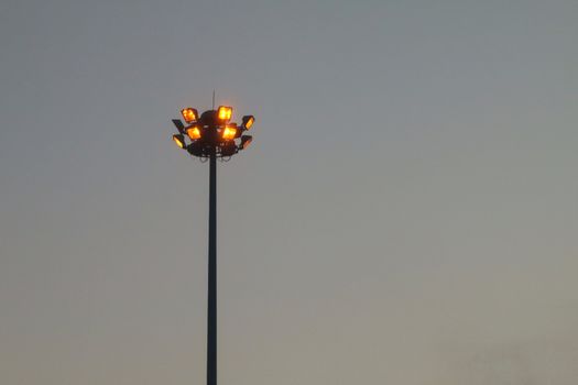 Light orange pole big on the highway, superhighway lighting column at night.