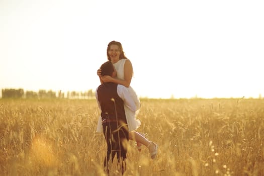 Happy bride and groom hug each other in the park at sunset. Wedding. Happy love concept. High quality photo