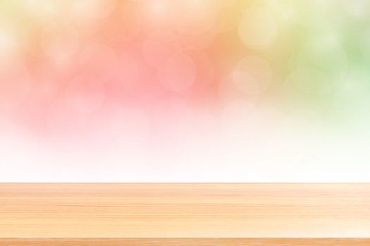 empty wood table floors on blurred bokeh soft pink gradient background, wooden plank empty on green pink bokeh colorful light shade, colorful bokeh lights gradient soft for banner advertising products