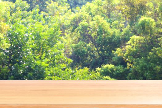 empty wood table floors on blurred tree nature green forest background, wood table board empty front blur tree, wooden plank blank with perspective brown wood table for mock up display products