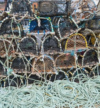 Commercial lobster fishing pots stacked on quayside of a fishing port