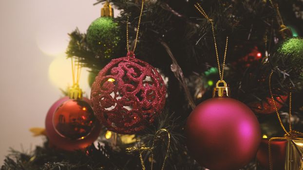 Greeting Season concept.close up of ornaments on a Christmas tree with decorative light