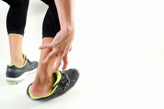 Runner sportsman holding ankle in pain with Broken twisted joint running sport injury and Athletic man touching foot due to sprain on white background