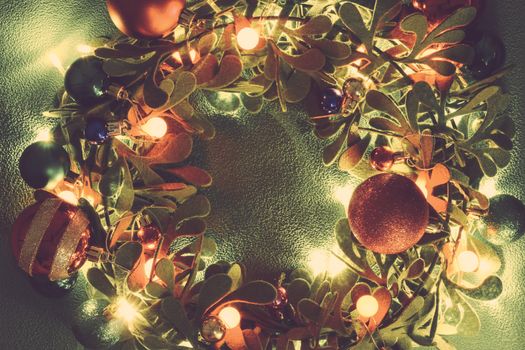 Greeting Season concept.Christmas wreath with decorative light on green background