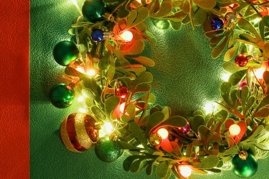 Greeting Season concept.Christmas wreath with decorative light on green background