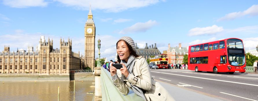 London travel banner with woman tourist, Big Ben and red double decker bus. Girl taking photo on Westminster Bridge with smartphone camera over River Thames, London, England, Great Britain, UK.
