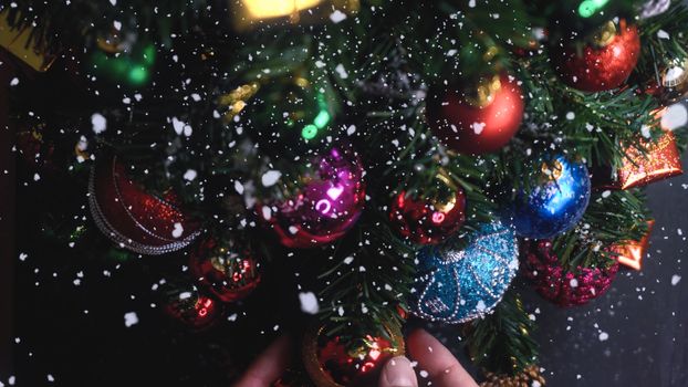 Greeting Season concept.hand setting of ornaments on a Christmas tree with decorative light