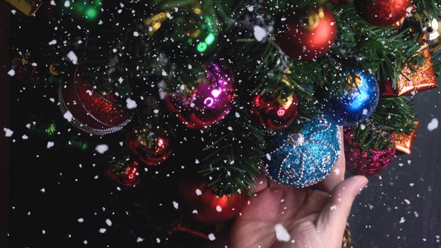 Greeting Season concept.hand setting of ornaments on a Christmas tree with decorative light