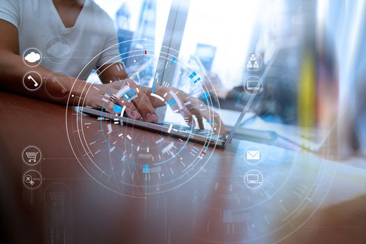 Hands of businessman using mobile phone in modern office with laptop and digital tablet computer in team meeting with VR icon diagram