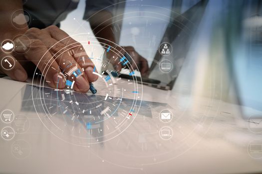 Hands of businessman using mobile phone in modern office with laptop and digital tablet computer in finance team meeting with VR icon diagram