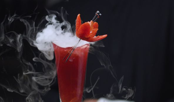 Close up ready-made Strawberry Rossini Cocktail with dry ice. Bar drinks series.