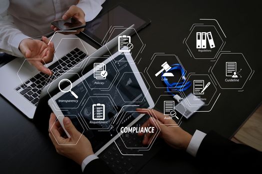 Compliance Virtual Diagram for regulations, law, standards, requirements and audit.co working team meeting concept,businessman using smart phone and digital tablet and laptop computer and name tag in modern office