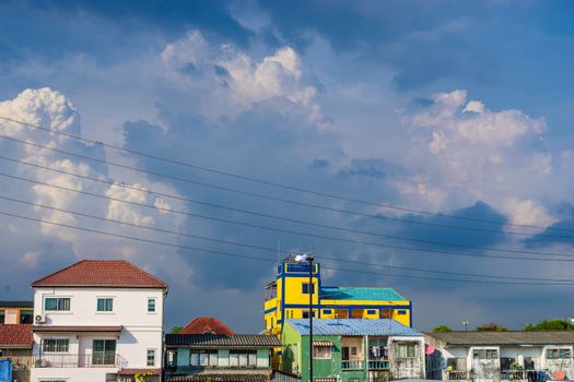 Background of electricity pole system with home in city with cloudy sky