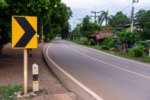 traffic sign placed beside along the road in countryside, signal turn right