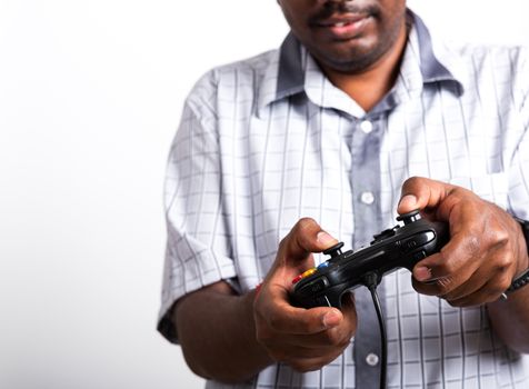 Asian happy portrait young black man funny use hand playing video game pad joystick controller, studio shot isolated on white background