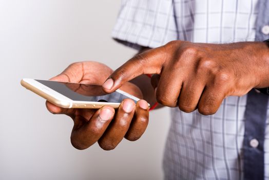 Closeup hand black man holding mockup white modern digital mobile smart phone blank screen on hand and point a finger to touch the screen, studio shot isolated on white background