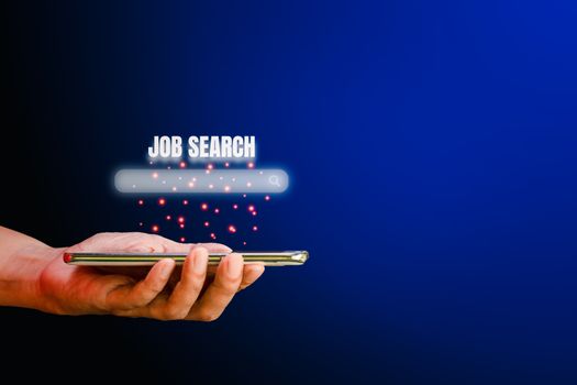 Job search concept. Hand holding smartphone with a search box for looking job on blue background with copy space. 