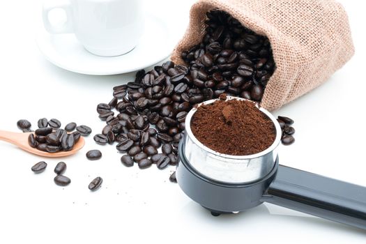 Roasted coffee beans in a sack of cloth on a white background