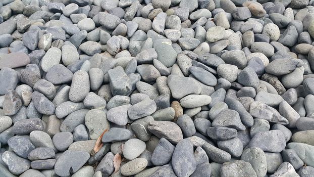 Texture background: Rock Pebbles, small, rounded, smooth pibbles with copy space for text