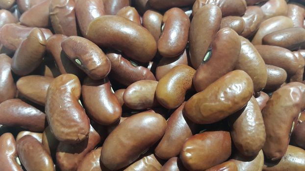 Kidenry beans:   Closeup view of uncooked red kidney beans. Dark red useful beans background.