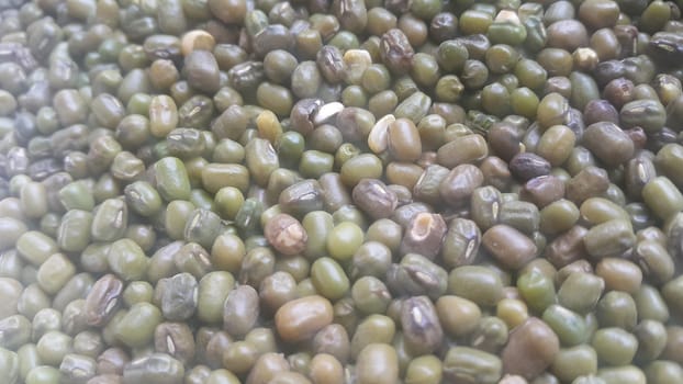 Closeup view of green whole Mung bean or green gram, maash, or moong. It is used as an ingredient in both savory and sweet dishes.