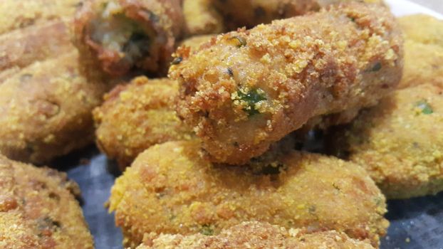 Closeup perspective view of home made spicy and delicious croquettes served with tea or other dishes during parties as fast food.