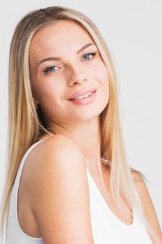 Beautiful smiling woman with long straight hair on a white background beauty skincare concept