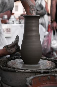 Sibiu City, Romania - 31 August 2019. Hands of a potter shaping a clay pot on a potter's wheel at the potters fair from Sibiu, Romania