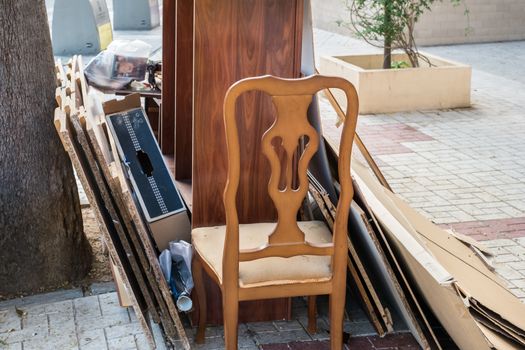 Malaga, Spain - May 20, 2018. Home furniture thrown in the the street in the city polluting the town and environment