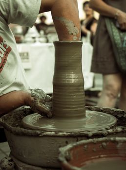 Sibiu City, Romania - 31 August 2019. Hands of a potter shaping a clay pot on a potter's wheel at the potters fair from Sibiu, Romania