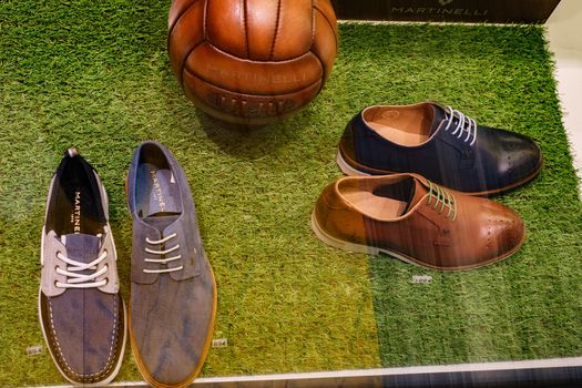 Malaga, Spain - May 05, 2018. shoe store for men and a leather ball in Martinelli shop window from Malaga city, Spain