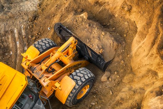 Ruse city, Bulgaria - September 18, 2017, The modern excavator performs excavation work on the construction site in Ruse city, Bulgaria.