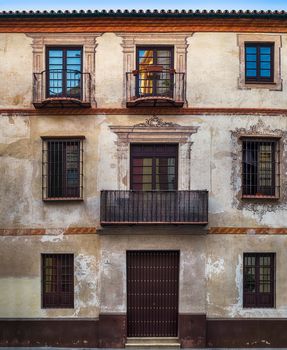 Malaga, Spain - August 06, 2018. Typical building facade with balconies in Malaga city, Andalucia, Spain